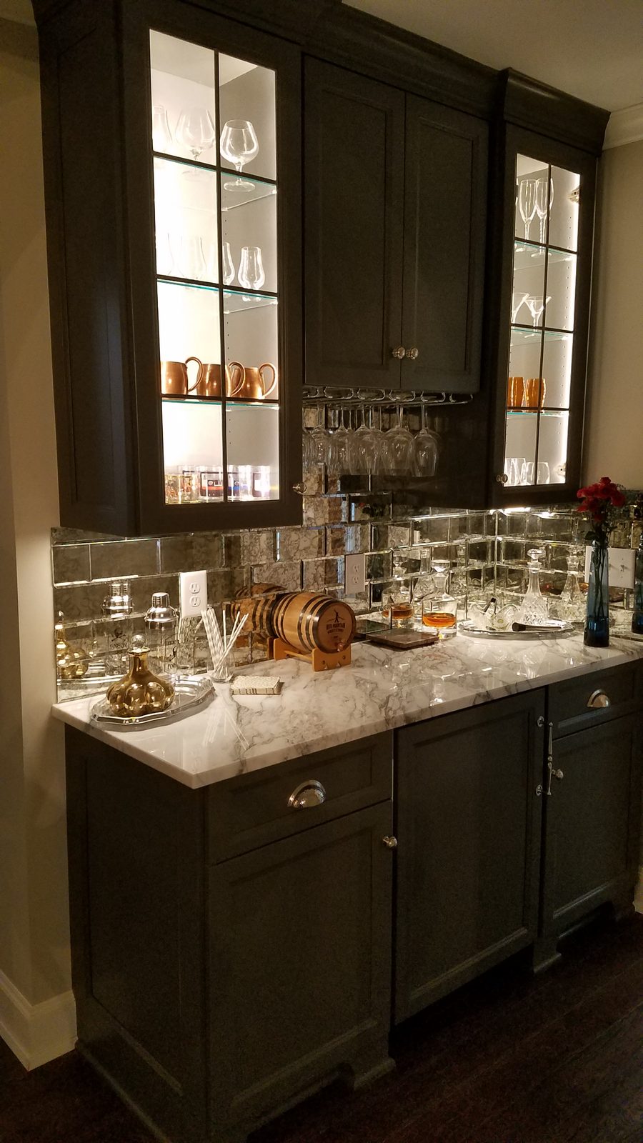 Custom basement bar with mirror backsplash