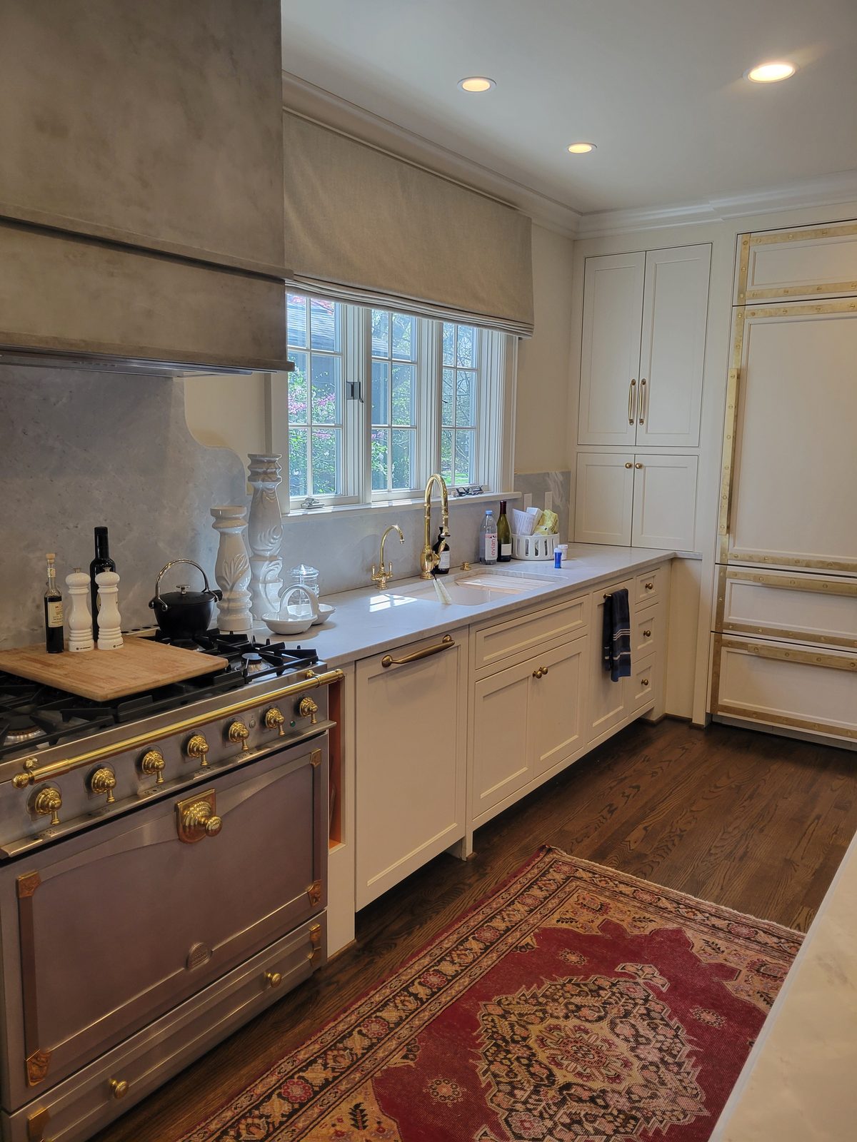 White kitchen with brass range