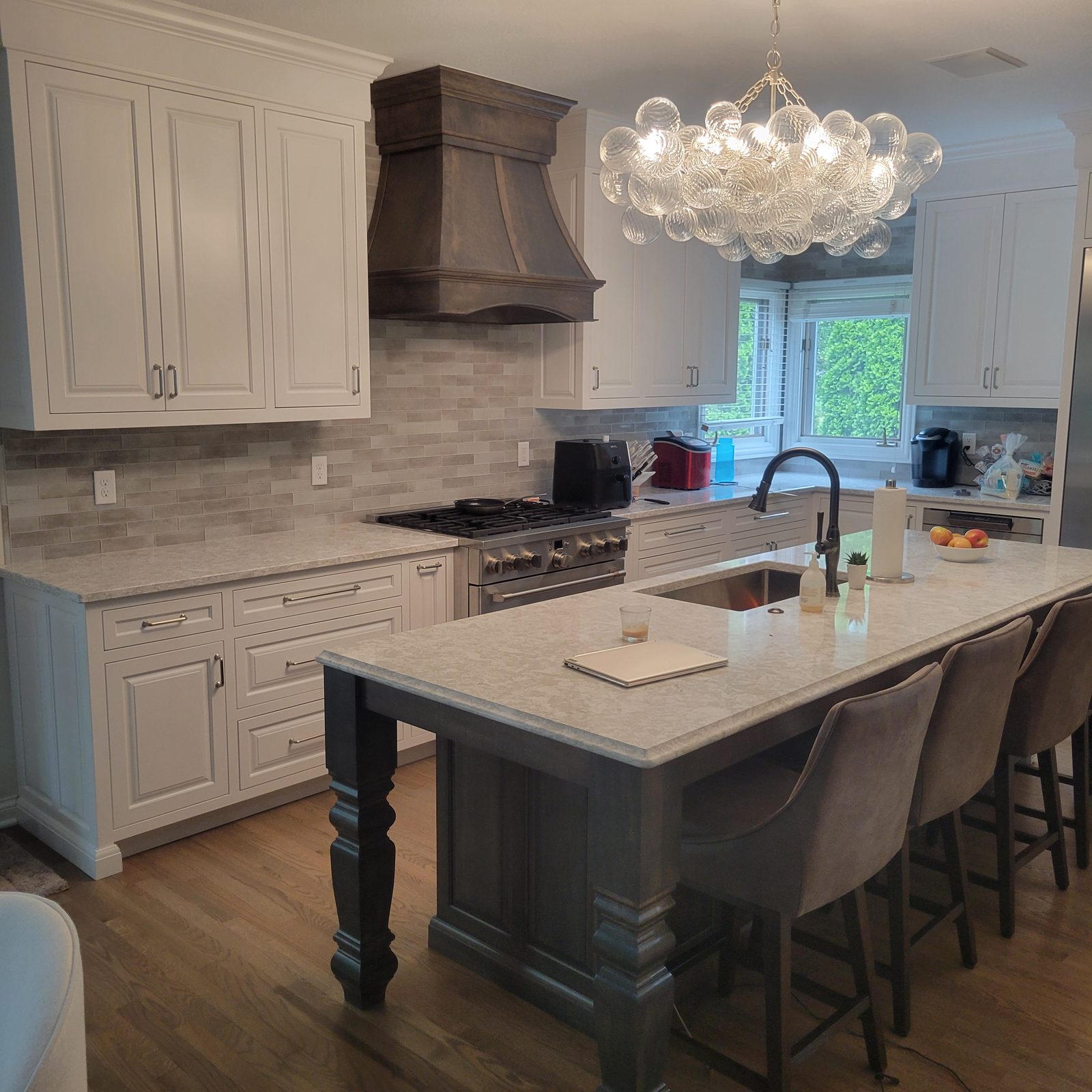 Custom white kitchen with island by Keeler Carpentry